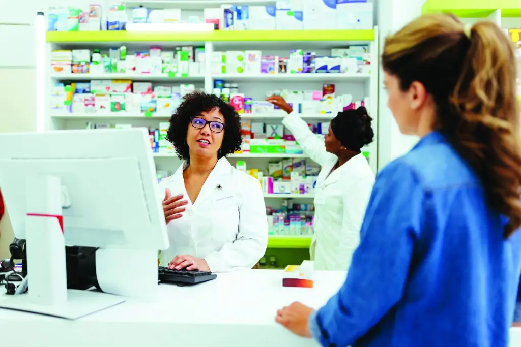 Pharmacist speaking with a customer